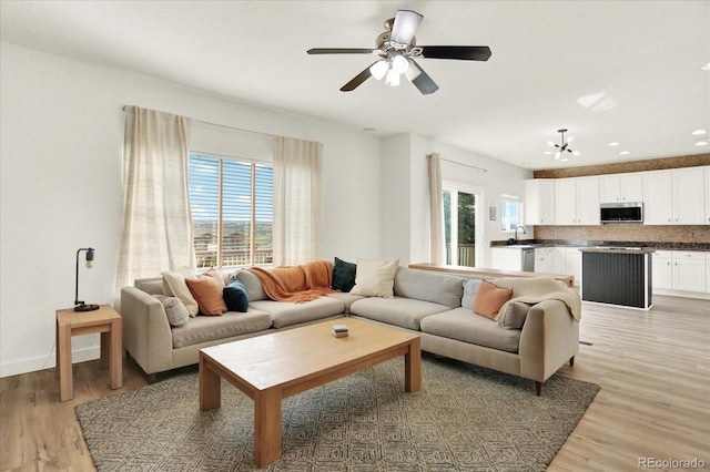 11575 Wilson Cir, Parker, CO 80134 - living room with light wood-style floors, a ceiling fan, and recessed lighting