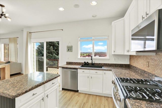 11575 Wilson Cir, Parker, CO 80134 - kitchen with appliances with stainless steel finishes, light wood-style flooring, white cabinets, and recessed lighting