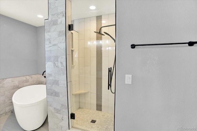 11575 Wilson Cir, Parker, CO 80134 - full bathroom featuring a shower stall, a soaking tub, tile walls, and recessed lighting