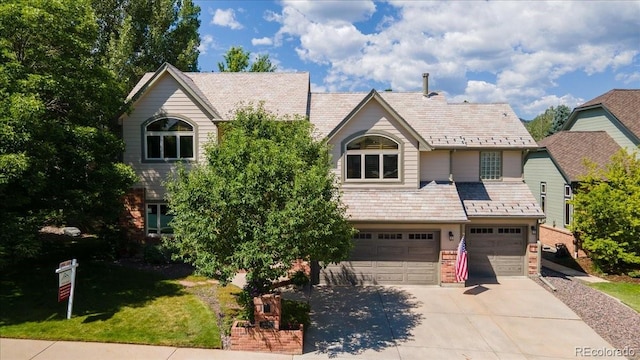 16642 W Archer Ave, Golden, CO 80401 - view of front of property featuring a high end roof, an attached garage, concrete driveway, and a front lawn