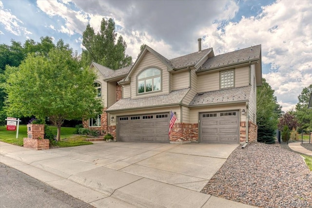 16642 W Archer Ave, Golden, CO 80401 - view of front facade featuring an attached garage, driveway, and brick siding
