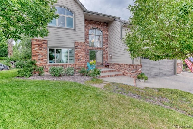 16642 W Archer Ave, Golden, CO 80401 - traditional-style house featuring driveway, a front yard, and brick siding