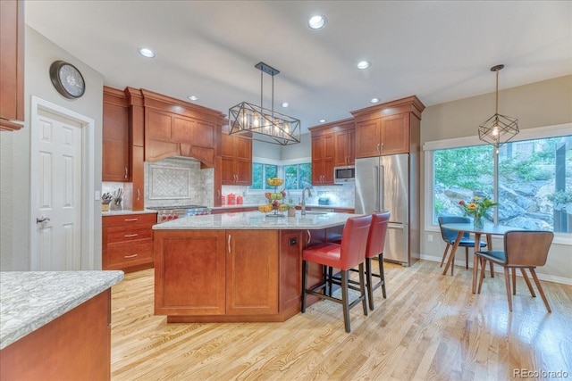 16642 W Archer Ave, Golden, CO 80401 - kitchen featuring stainless steel appliances, tasteful backsplash, light wood-type flooring, recessed lighting, and decorative light fixtures