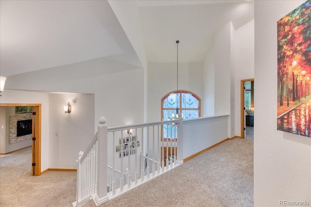 16642 W Archer Ave, Golden, CO 80401 - hall with carpet, high vaulted ceiling, an upstairs landing, and a chandelier