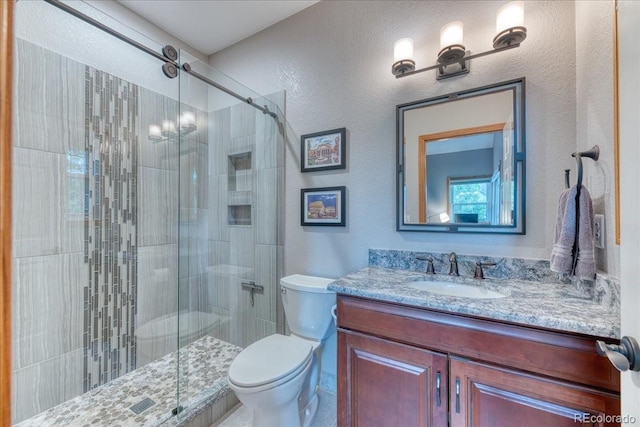 16642 W Archer Ave, Golden, CO 80401 - bathroom featuring a stall shower, vanity, and a textured wall