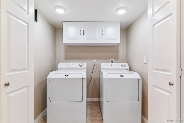 9015 W Tanforan Dr, Littleton, CO 80123 - washroom with cabinet space, washing machine and clothes dryer, and light wood-style flooring
