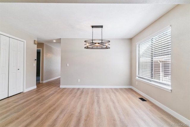 9015 W Tanforan Dr, Littleton, CO 80123 - unfurnished dining area featuring light wood-style flooring and a chandelier