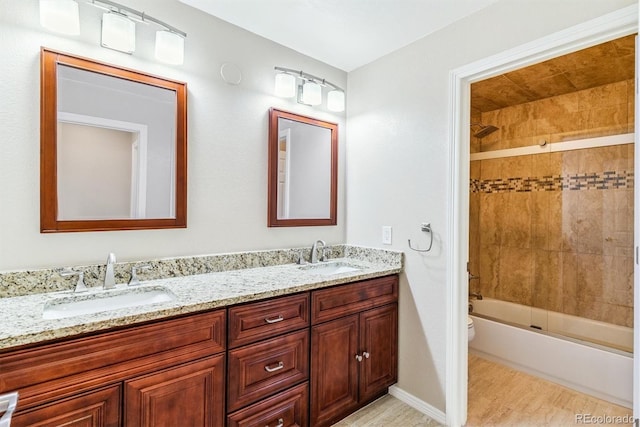 9015 W Tanforan Dr, Littleton, CO 80123 - bathroom featuring double vanity, wood finished floors, and  shower combination