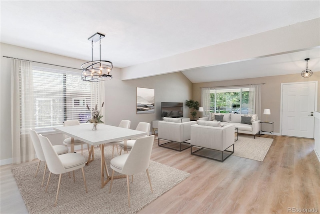 9015 W Tanforan Dr, Littleton, CO 80123 - dining room featuring light wood-type flooring, a chandelier, and lofted ceiling