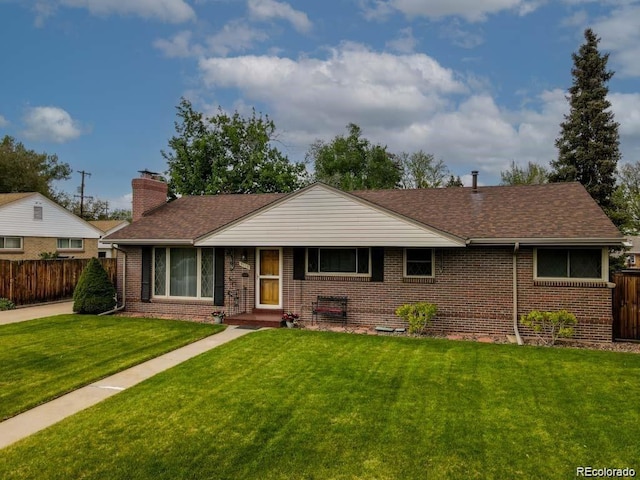 9115 W 5th Ave, Lakewood, CO 80226 - view of front of home featuring brick siding, a chimney, and roof with shingles