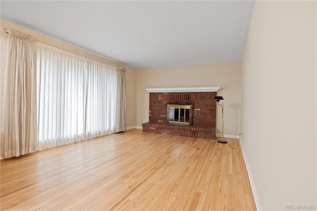 9115 W 5th Ave, Lakewood, CO 80226 - unfurnished living room featuring wood finished floors, healthy amount of natural light, and baseboards