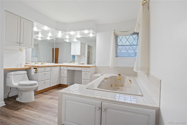 9115 W 5th Ave, Lakewood, CO 80226 - full bathroom with a whirlpool tub, wood finished floors, vanity, and toilet