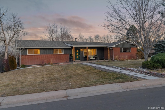 ranch-style home featuring a lawn