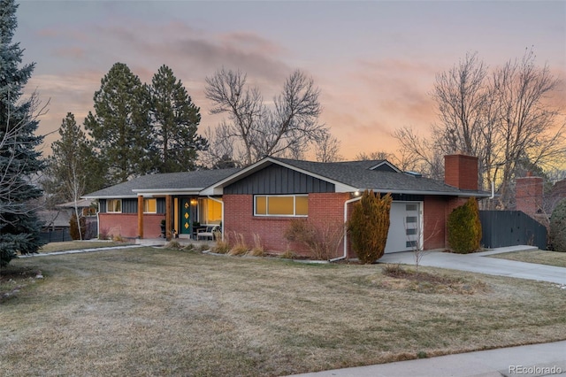 ranch-style home with a lawn