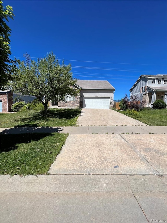 view of front of house with a garage and a front lawn