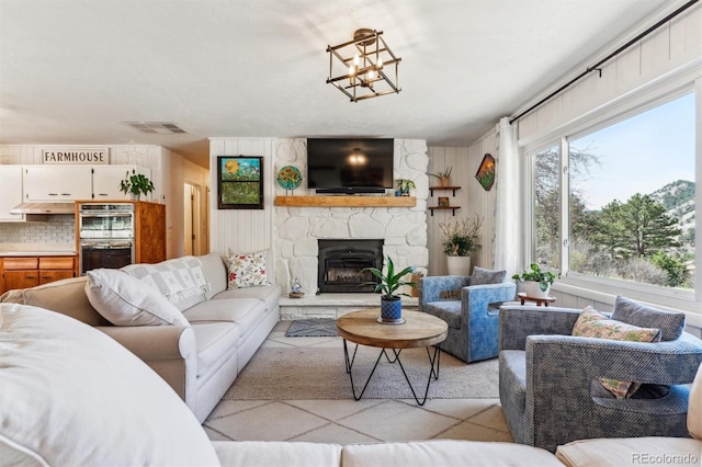 5384 Olde Stage Rd, Boulder, CO 80302 - living room featuring visible vents and a stone fireplace