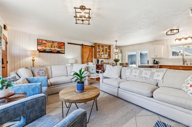 5384 Olde Stage Rd, Boulder, CO 80302 - living area featuring visible vents, a barn door, and wooden walls