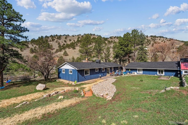 5384 Olde Stage Rd, Boulder, CO 80302 - view of front facade with board and batten siding, fence, and a front yard