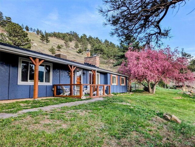 5384 Olde Stage Rd, Boulder, CO 80302 - rear view of house featuring a yard and a chimney