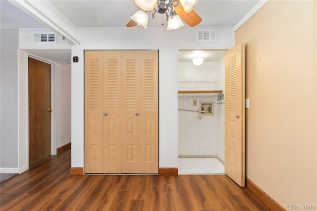 unfurnished bedroom featuring a closet, visible vents, and wood finished floors