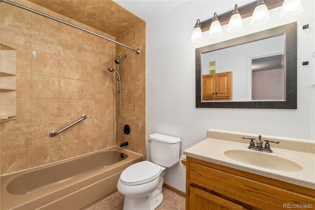 bathroom featuring toilet, tile patterned flooring, baseboards, bathing tub / shower combination, and vanity