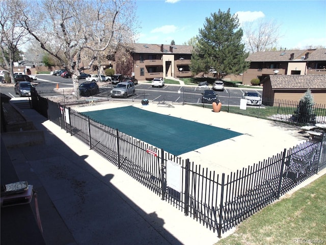 pool with a residential view and fence