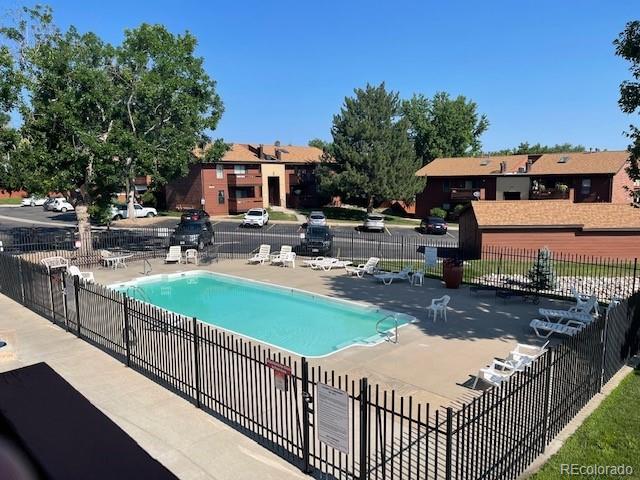 pool with fence and a patio
