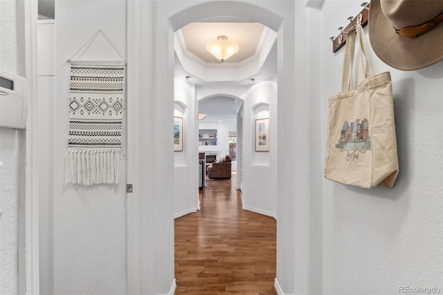 1776 Race St Unit 109, Denver, CO 80206 - corridor featuring arched walkways, wood finished floors, ornamental molding, and a raised ceiling