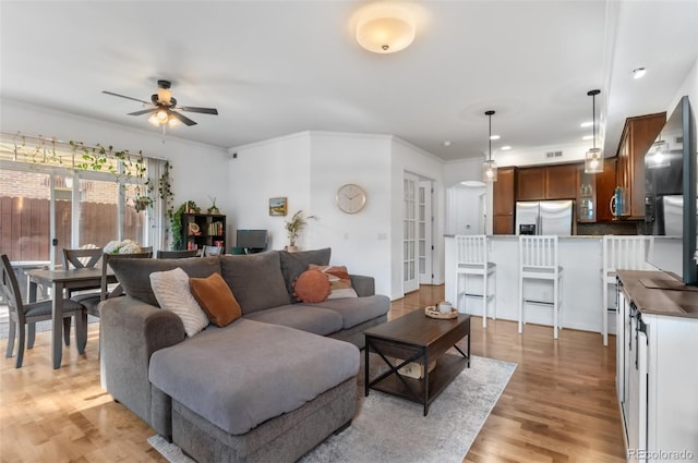 1776 Race St Unit 109, Denver, CO 80206 - living area featuring a ceiling fan, light wood-style floors, and ornamental molding