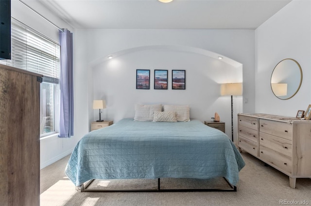 1776 Race St Unit 109, Denver, CO 80206 - bedroom featuring light carpet and arched walkways