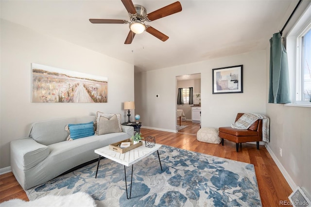 living room featuring hardwood / wood-style floors and ceiling fan