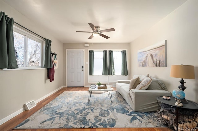 living room with hardwood / wood-style flooring, ceiling fan, and a wealth of natural light