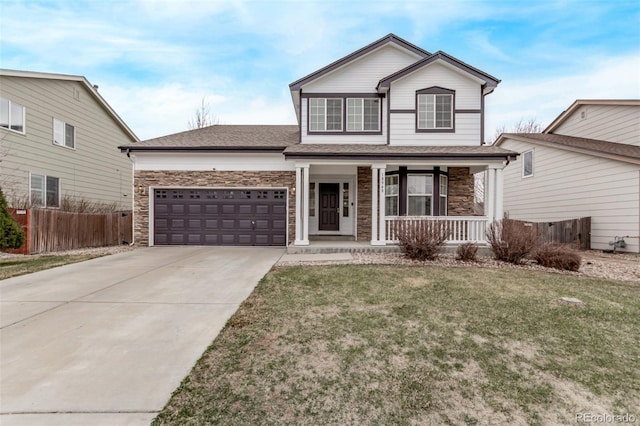 traditional-style home with stone siding, concrete driveway, an attached garage, fence, and a porch
