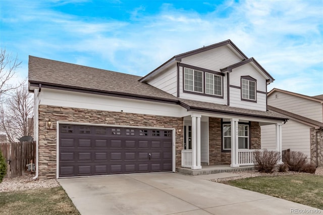 view of front facade featuring stone siding, fence, driveway, covered porch, and a shingled roof