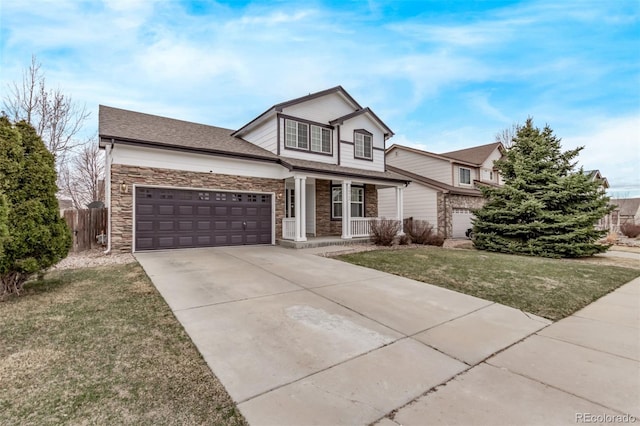 traditional-style house featuring driveway, a front yard, covered porch, fence, and an attached garage