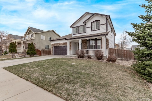 traditional-style home featuring a porch, concrete driveway, fence, and a front lawn