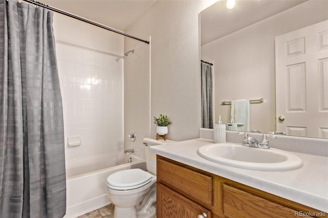 full bathroom with toilet, shower / bath combo, a textured wall, and vanity