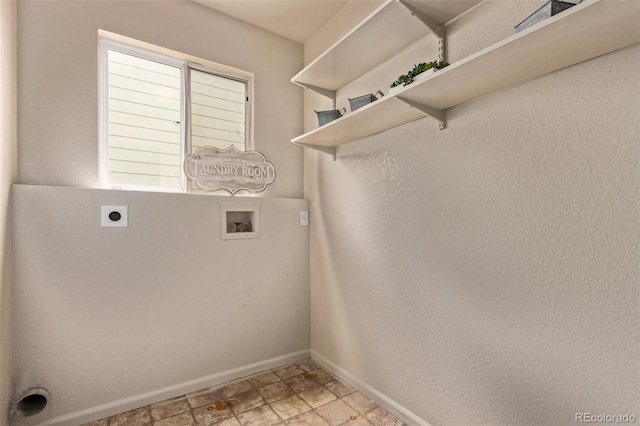 laundry room featuring hookup for an electric dryer, laundry area, stone finish floor, baseboards, and hookup for a washing machine