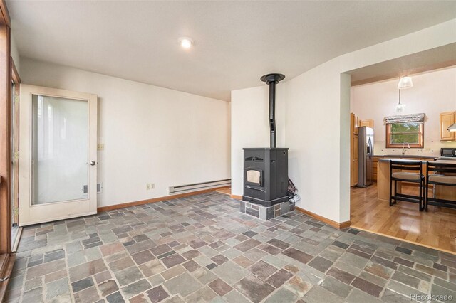 4436 W 17th St, Greeley, CO 80634 - living area with a baseboard radiator, baseboards, and stone finish floors