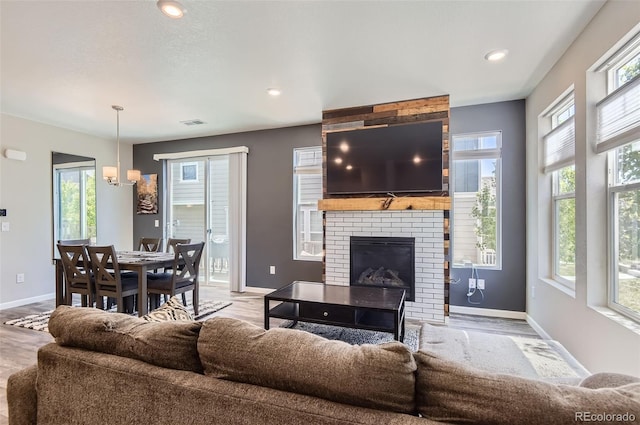 living room with baseboards, wood finished floors, and recessed lighting
