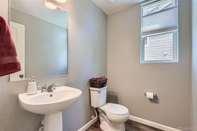 bathroom featuring wood finished floors, toilet, and baseboards