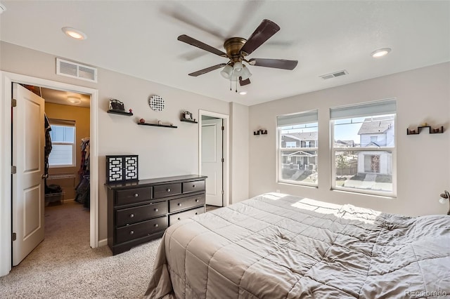 bedroom with multiple windows, light carpet, recessed lighting, ceiling fan, and baseboards