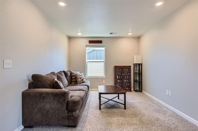 carpeted living area with baseboards and recessed lighting