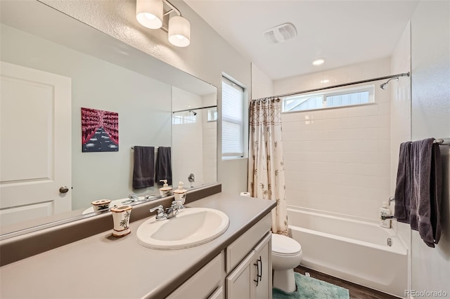 bathroom featuring vanity, toilet, shower / bath combo, and wood finished floors