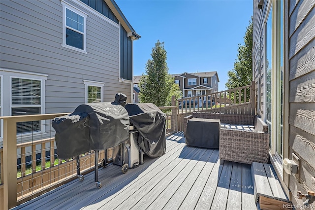 wooden deck featuring a grill