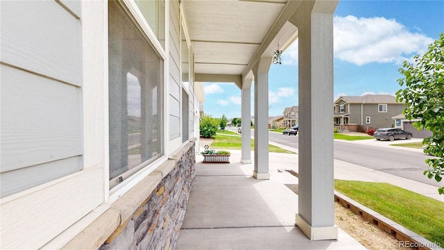 view of patio with a residential view and a porch