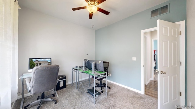 office area with ceiling fan, carpet flooring, visible vents, and baseboards