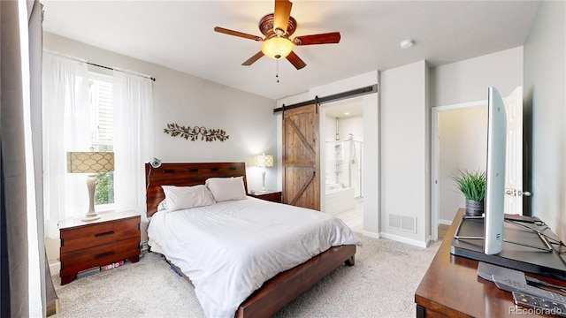 bedroom featuring light carpet, a barn door, visible vents, baseboards, and ceiling fan