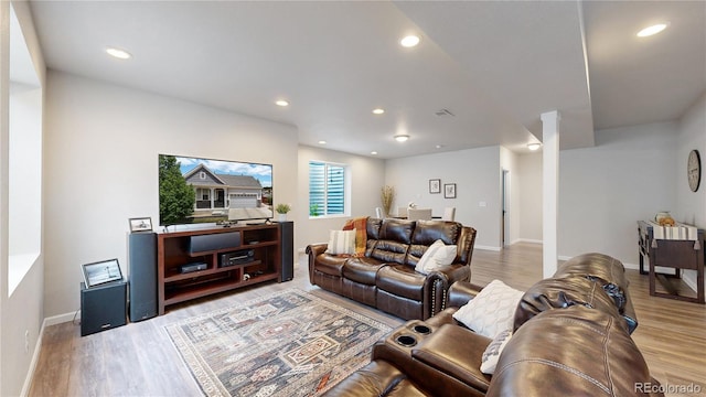 living room with recessed lighting, baseboards, and wood finished floors