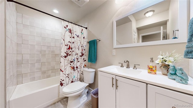 bathroom with toilet, shower / tub combo, visible vents, and vanity